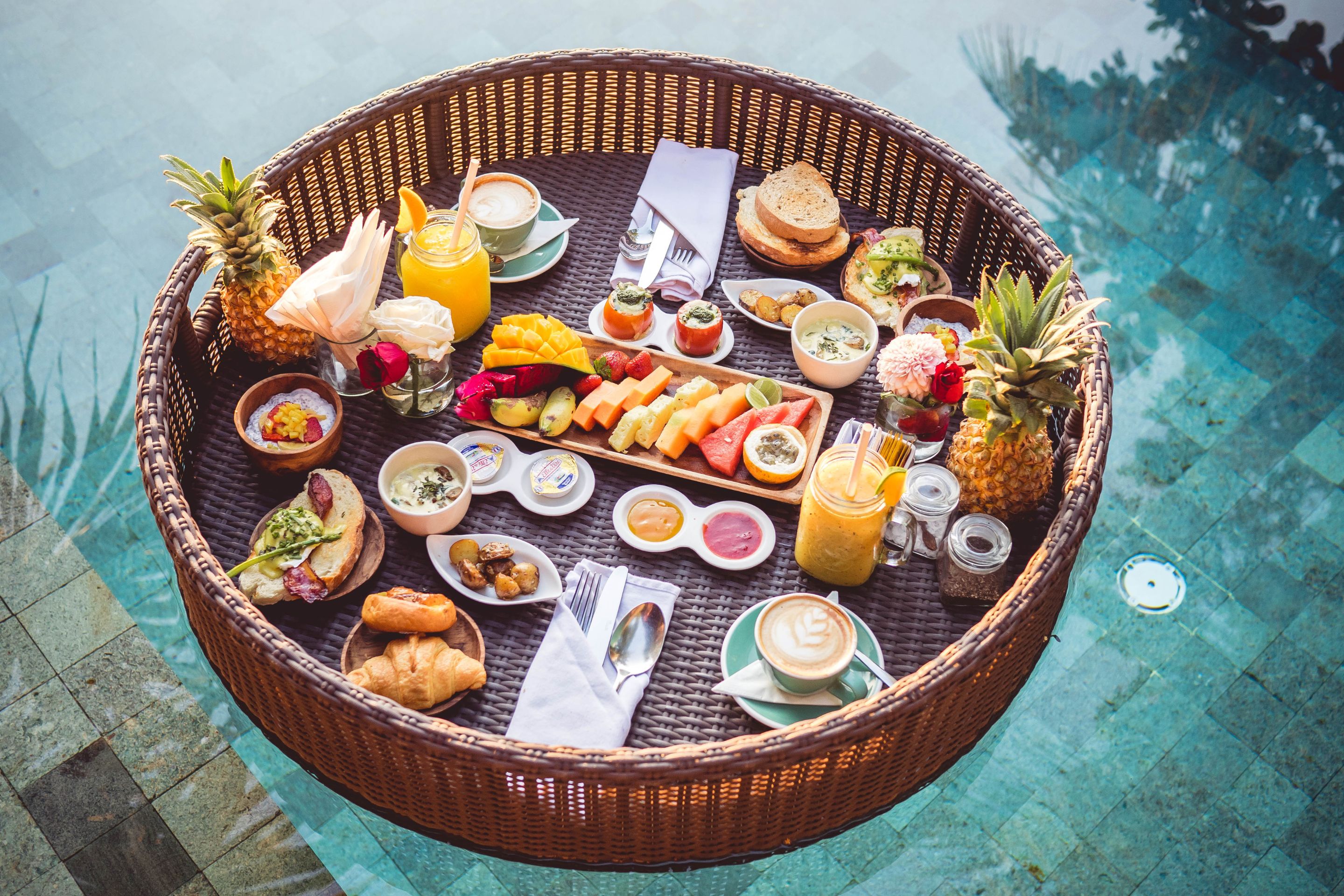 Floating breakfast with juices, coffee, fruit and croissants