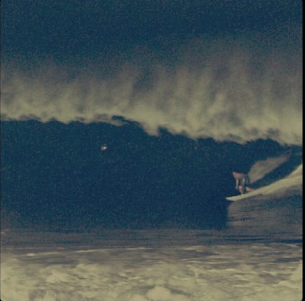 Lee Wilson on a fifteen-foot wave under floodlights at the Keramas night surfing launch, Hotel Komune Bali