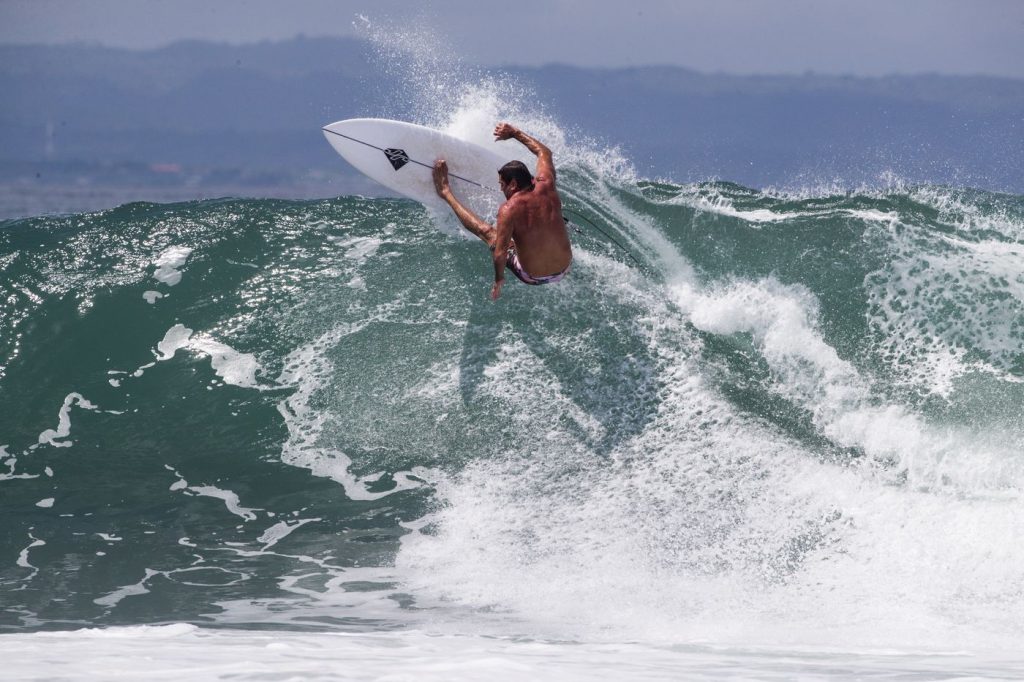 Tony Cannon hitting the lip on a powerful turn at Keramas surf break, Bali