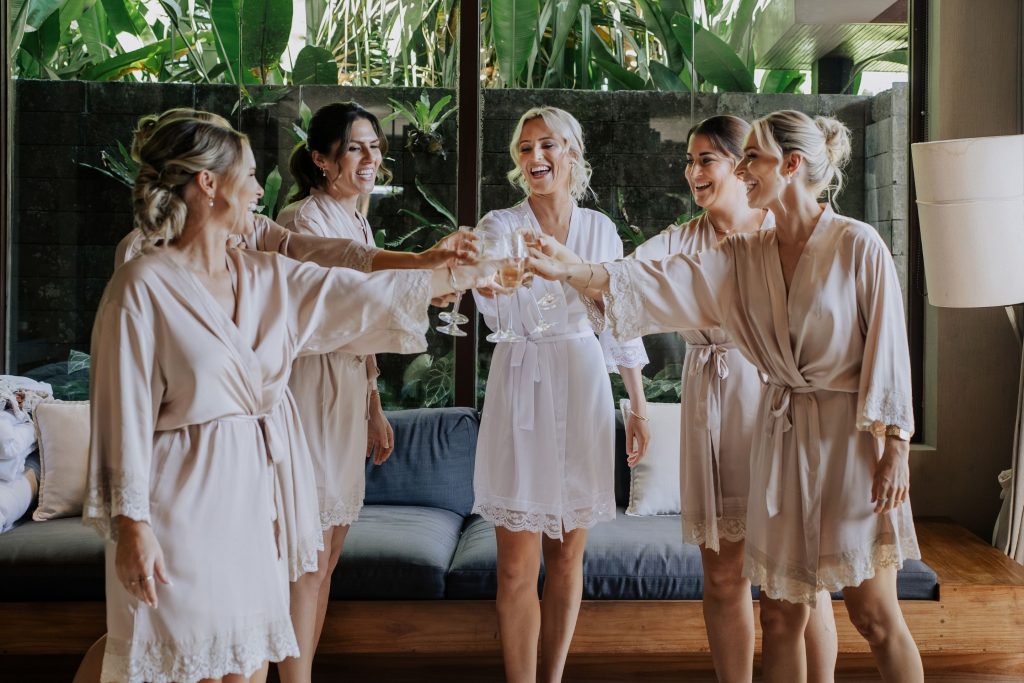 Kayla cheers champagne with her bridesmaids as they get ready for her special Bali wedding