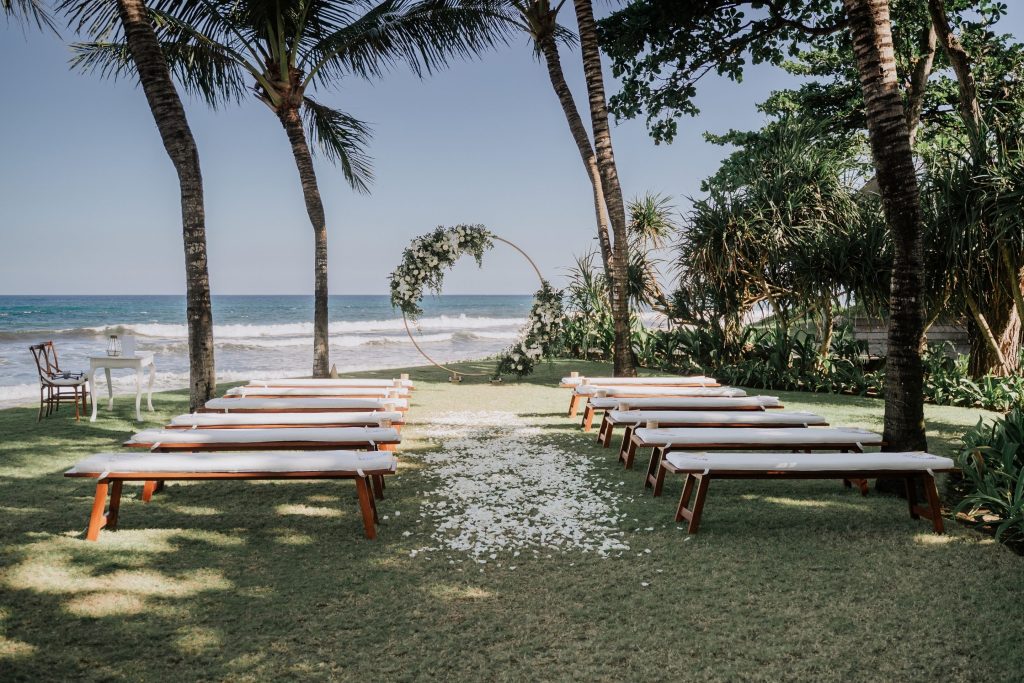 Kayla & Pete's beachfront wedding ceremony set up in front of world famous Keramas surf break